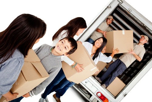 Removal team preparing boxes and furniture for a home move in Merton