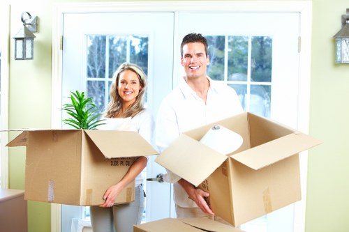 Local movers handling furniture in a Merton street