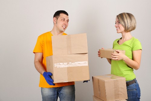 Trained movers handling boxes with care during relocation