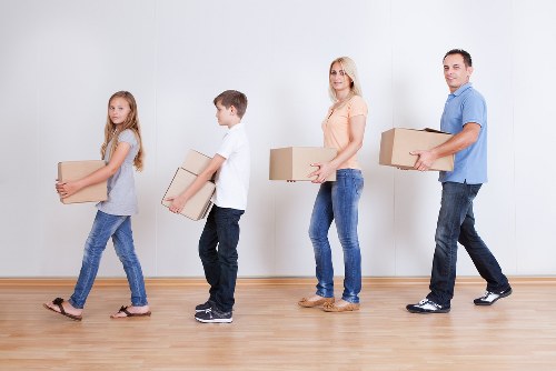Packed boxes and furniture ready for transport during a Merton house move